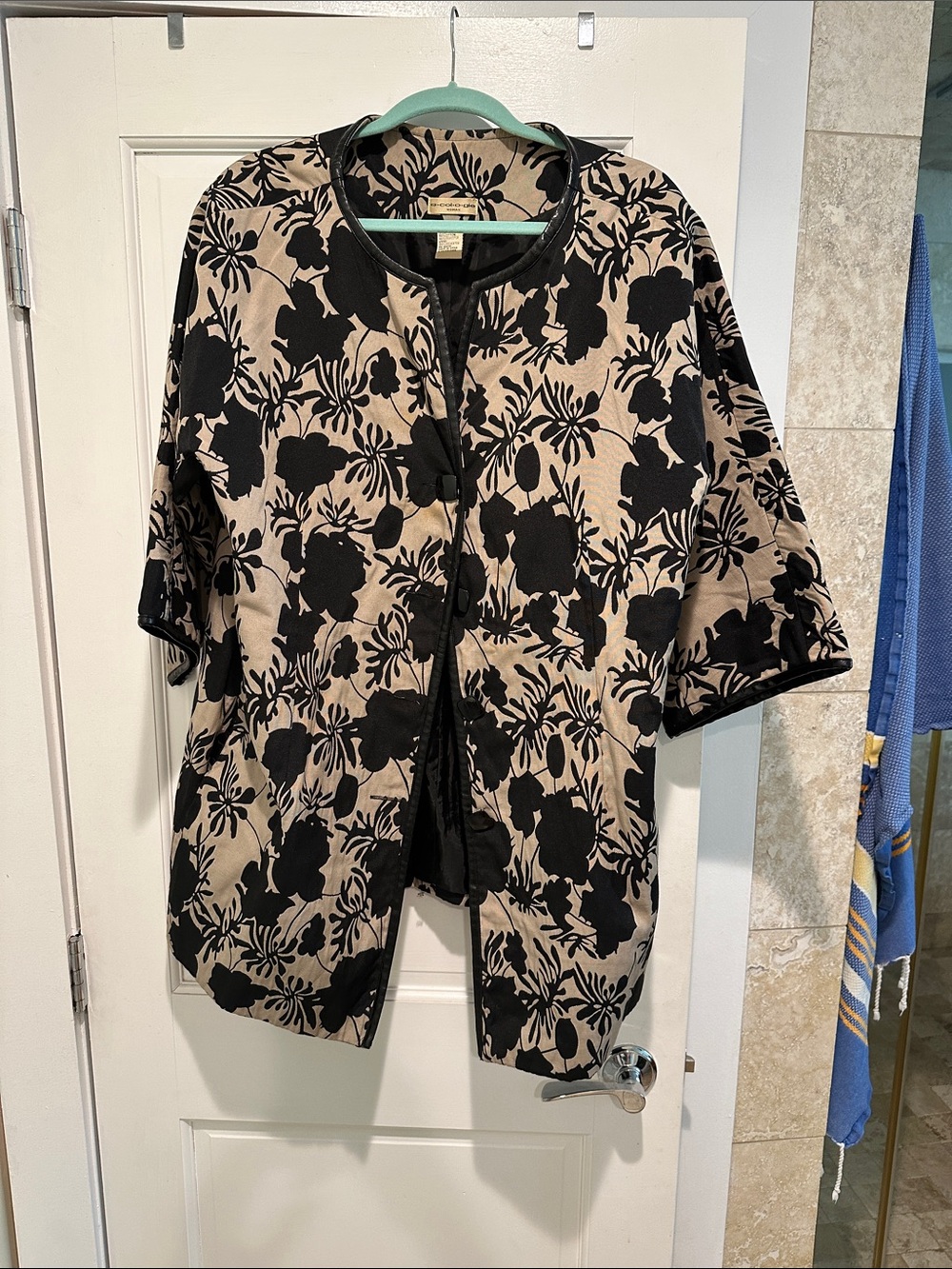 Black Floral Pattern Coatigan on Tan Background